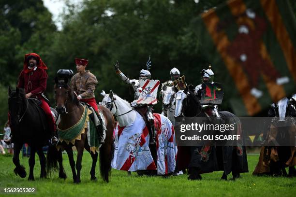 Steve Morris as 'Sir Lancelot' , Ben Green as 'The Wildman' and Chris Sailing as 'The Wyvern' acknowledge the crowds after competing in the Legendary...