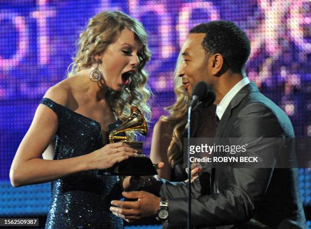 John Legend presents to Taylor Swift the award for the Best Album of the Year during the 52nd annual Grammy Awards in Los Angeles, California on...