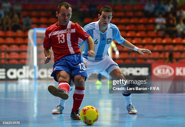 Vidan Bojovic of Serbia is challenged by Maximiliano Rescia of Argentina during the FIFA Futsal World Cup Round of 16 match between Serbia and...