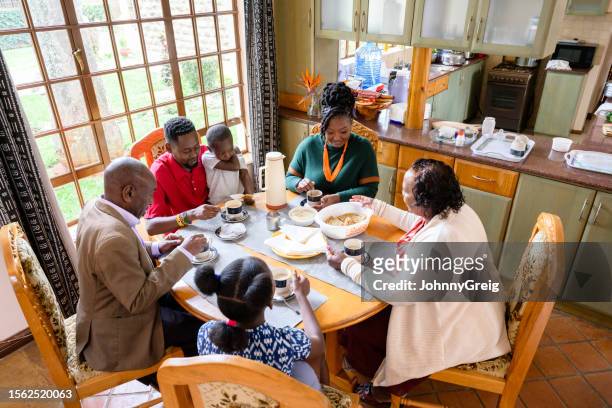 three-generation african family enjoying snack together - kenyansk kultur bildbanksfoton och bilder