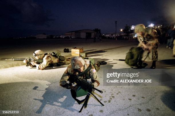 Marines take position to take control of the airport after disembarking from a landing craft on the beach near Mogadishu airport on December 09, 1992...