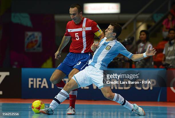 Bojan Pavicevic of Serbia is challenged by Maximiliano Rescia of Argentina during the FIFA Futsal World Cup Round of 16 match between Serbia and...