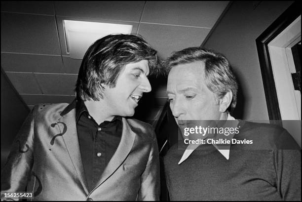 English singer-songwriter Nick Lowe with American singer Andy Williams , backstage at a recording of the BBC TV show 'Top Of The Pops', London, March...
