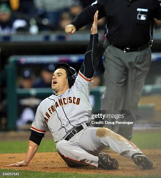 Ryan Theriot of the San Francisco Giants slides to home after a run off of Marco Scutaro of the San Francisco Giants an RBI single to center field...