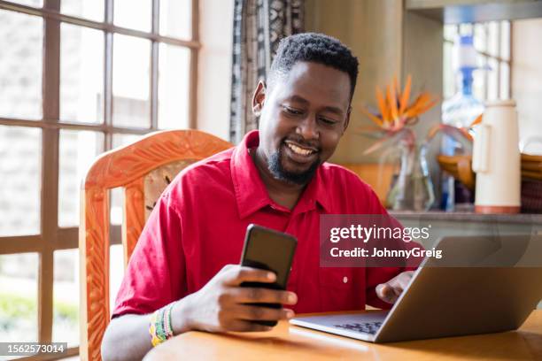 mid adult nairobi man working at home - kenya business stock pictures, royalty-free photos & images