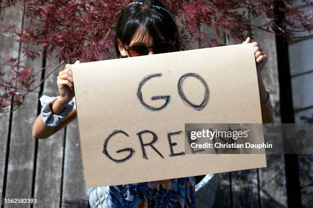 mixed-race teenager fights to save the environment and protest climate change.
she is holding cardboard signs. - adulte d'âge moyen stock pictures, royalty-free photos & images