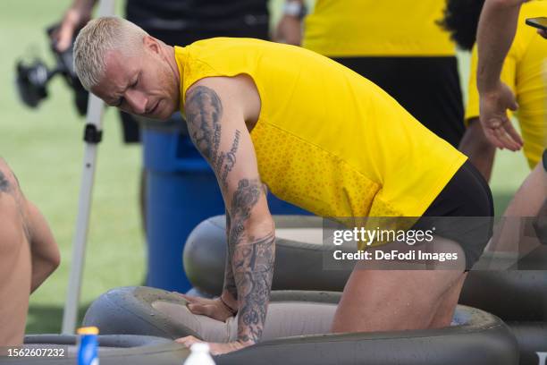 Marco Reus of Borussia Dortmund stands in the ice barrel during