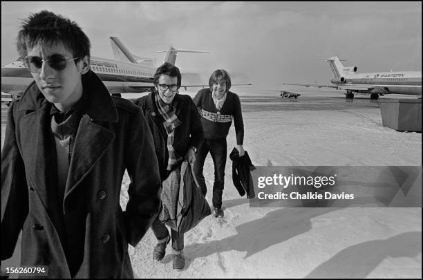 Keyboard player Steve Nieve and singer-songwriters Elvis Costello and Nick Lowe, arriving at Buffalo Niagara International Airport, New York, March...