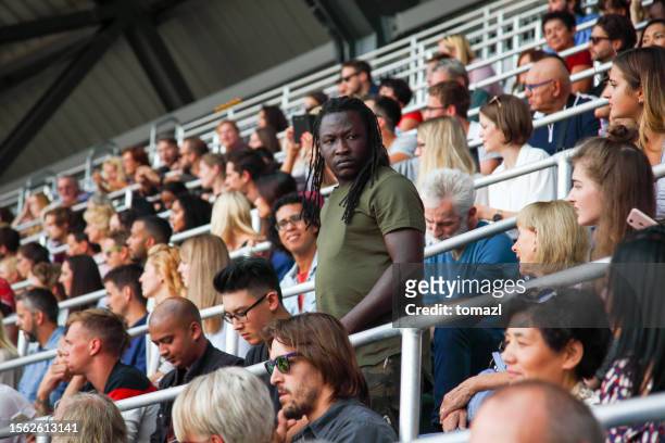 man in stadion audience - crowd anticipation stock pictures, royalty-free photos & images
