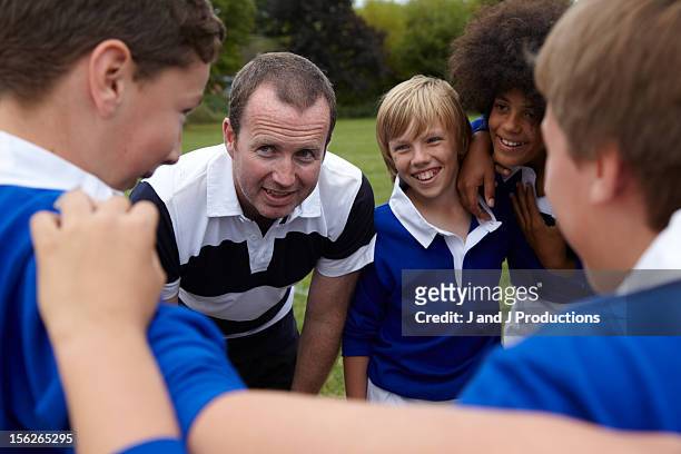 coach speaking to his team - kids rugby stock pictures, royalty-free photos & images