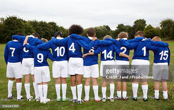 line up of young rugby players from behind - arm in arm stock pictures, royalty-free photos & images