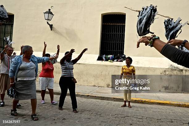 Women in the "Circulo de Abuelos," one of many exercise groups for senior women, goes through a routine in Old Havana on November 12, 2012 in Havana,...