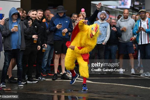 Cricket fan dressed as a chicken bowls a ball in a cricket game as rain delays the start of play on day four of LV= Insurance Ashes 4th Test Match...