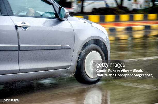 part of a car captured in a motion blur on a wet road during heavy rain - light rainfall in mumbai stock pictures, royalty-free photos & images