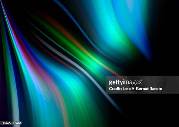 wavy moving blue and green light trails on a black background. - abstract background light stock pictures, royalty-free photos & images