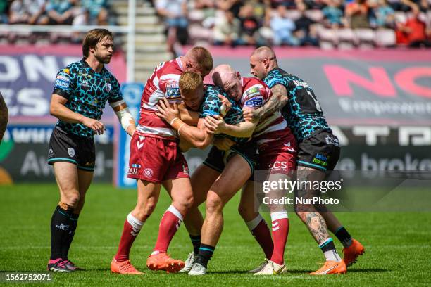 Leigh Leopards' Jack Hughes is tackled during the BetFred Super League match between Wigan Warriors and Leigh Leopards at the DW Stadium, Wigan on...