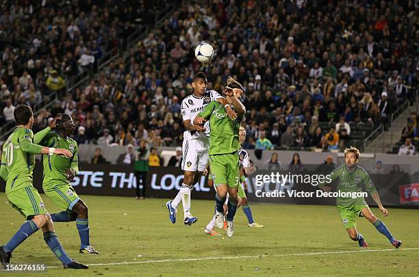 Sean Franklin of the Los Angeles Galaxy and Jeff Parke of the Seattle Sounders vie for the cross into the box during Leg 1 of the Western Conference...