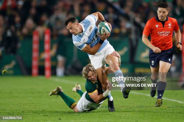 Argentina's wing Mateo Carreras runs with the ball as he is tackled by South Africa's scrumhalf Faf de Klerk during the Rugby Championship...