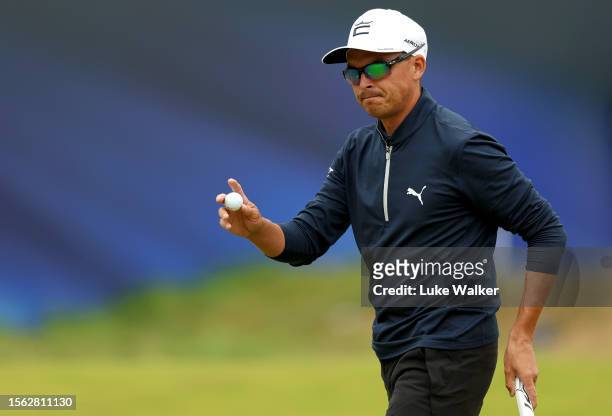 Rickie Fowler of the United States raises their ball as they acknowledge the crowd after putting on the 18th green on Day Three of The 151st Open at...