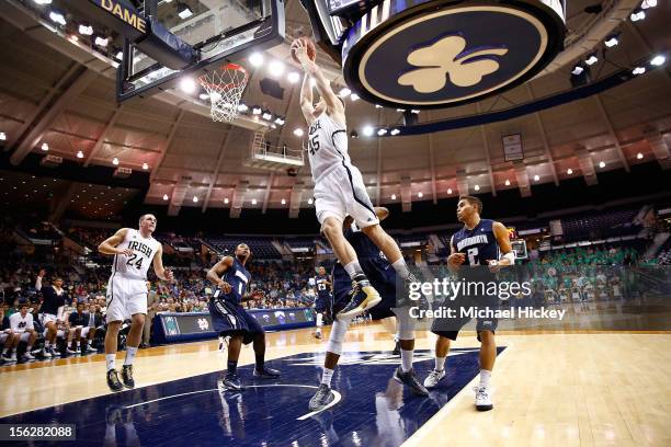 Jack Cooley of the Notre Dame Fighting Irish flies through the air to dunk against the Monmouth Hawks at Purcel Pavilion on November 12, 2012 in...