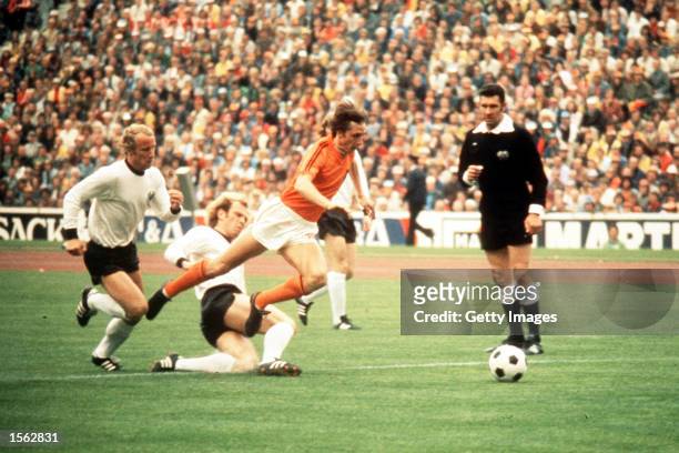 Johan Cruyff of Holland jumps a tackle from Uli Hoeness of West Germany during the 1974 World Cup Final. Mandatory Credit: Allsport UK/ALLSPORT