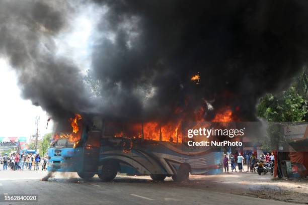View shows a fire on a public bus after the supporters of the Bangladesh Nationalist Party set it on fire in Shonir Akhra area while staging sit-in...