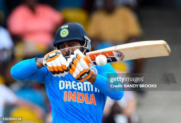 Ravindra Jadeja of India attempts to hit Romario Shepherd of West Indies ball during the 2nd ODI cricket match between West Indies and India, at...