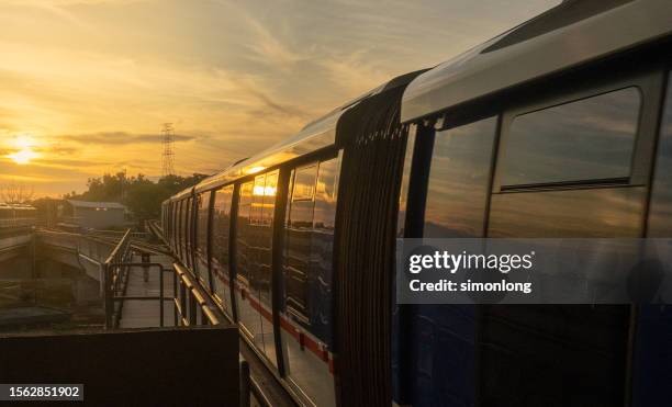 light rail commuter train during sunset - lightrail stock-fotos und bilder