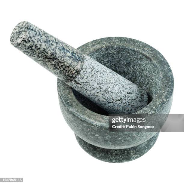 mortar and the pestle are made of stone isolated on a white background, clipping path - homeopathie stockfoto's en -beelden