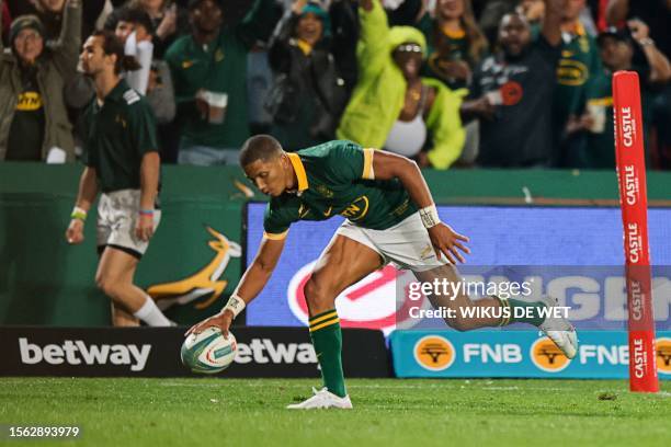 South Africa's flyhalf Manie Libbok runs to score a try during the Rugby Championship final-round match between South Africa and Argentina at Ellis...