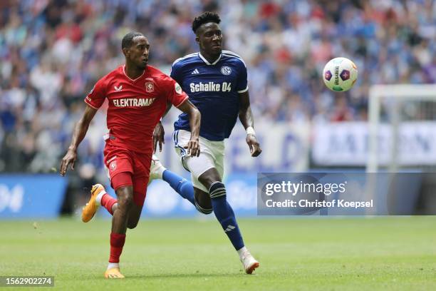 Joshua Brenet of Enschede challenges Bryan Lasme of Schalke during the pre-season friendly match between FC Schalke 04 and FC Twente at Veltins Arena...