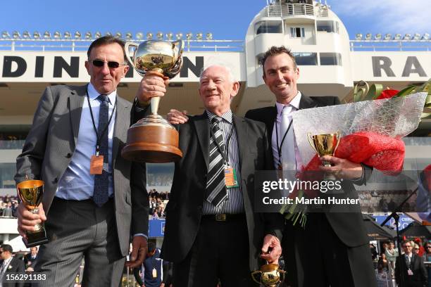 Graham Court, Terry McDonald and Paul Court celebrate with their trophies after their horse Terror To Love won the NZ Trotting Cup during the NZ...