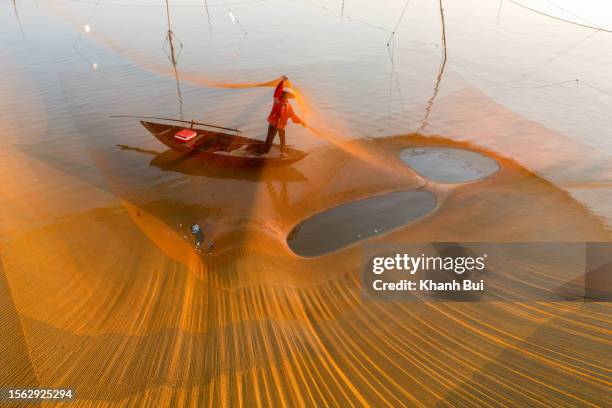 art of photography with traditional fishing craft - creative fishing stock-fotos und bilder