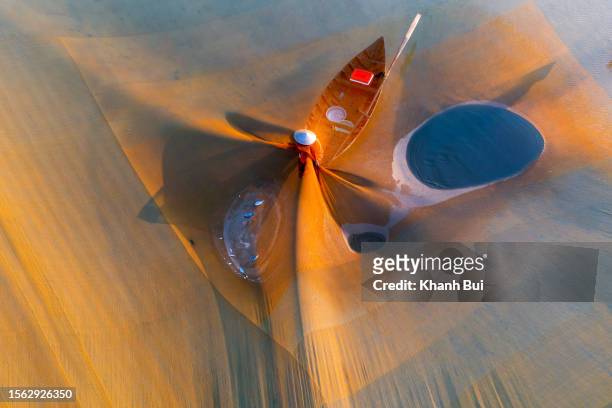 art of photography with traditional fishing craft - creative fishing stock-fotos und bilder