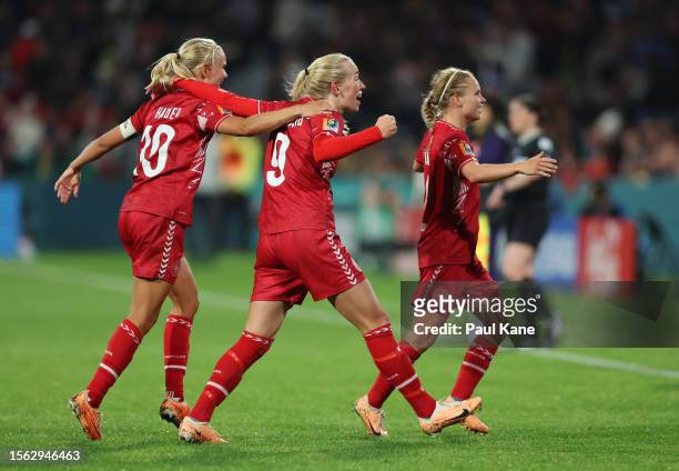 Amalie Vangsgaard of Denmark celebrates with teammates Pernille Harder and Josefine Hasbo after scoring her team's first goal during the FIFA Women's...
