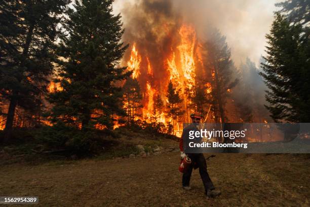 Wind change increased flames during a planned ignition on the Ross Moore Lake wildfire in Kamloops, British Columbia, Canada, on Friday, July 28,...