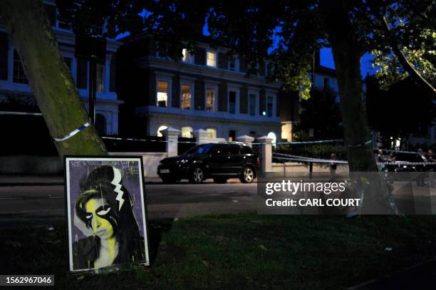 Painting of Amy Winehouse is left near the house in north London where the body of the English pop star was found earlier on July 23 2011. Troubled...