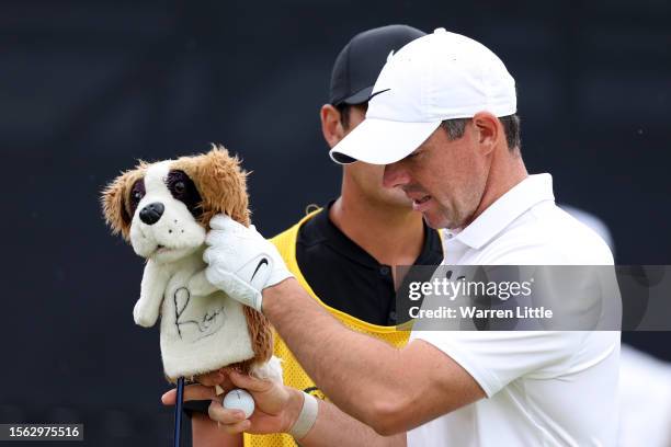 Rory McIlroy of Northern Ireland removes the Dog Driver Head Cover as they prepare to tee off on the 1st hole on Day Three of The 151st Open at Royal...