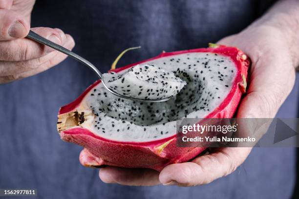 pitaya fruit. close-up of hands with dragon fruit. - pitaya stock pictures, royalty-free photos & images