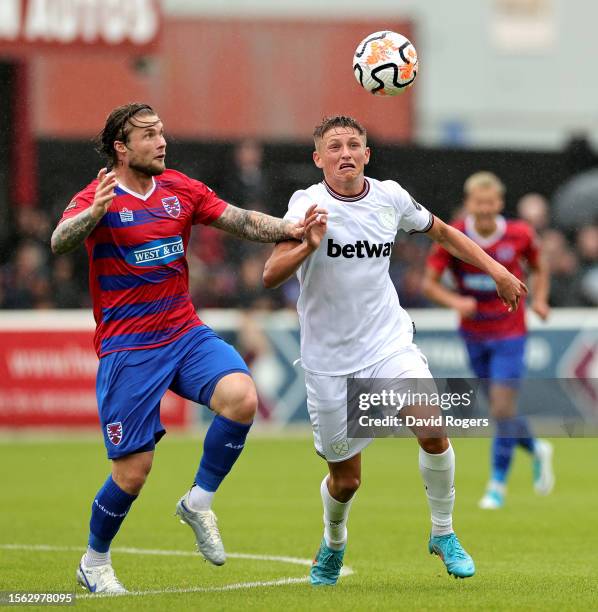 Callum Marshall of West Ham United is challenged by Elliot Johnson during the pre-season friendly match between Dagenham & Redbridge and West Ham...