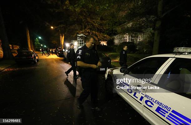 Charlotte police officers assist FBI agents during a search of the home of Paula Broadwell on November 13, 2012 in the Dilworth neighborhood of...