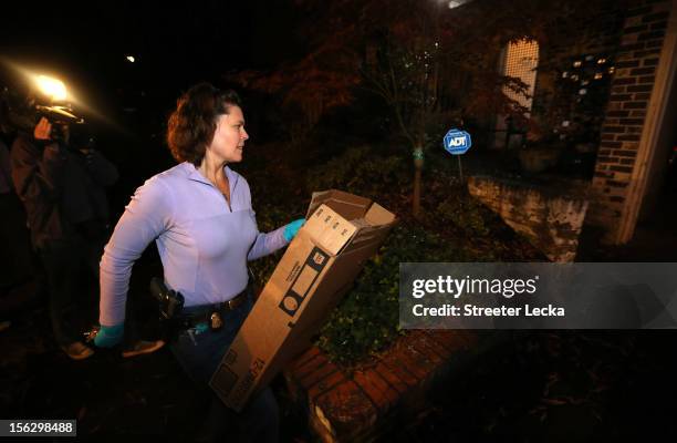An FBI agent removes a box after a search of the home of Paula Broadwell on November 13, 2012 in the Dilworth neighborhood of Charlotte, North...