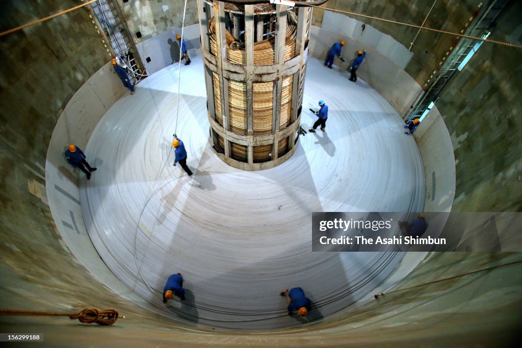 Subcom Loading Cable Workers spiral the water-proof fiber optic cable to the tank of... News ...