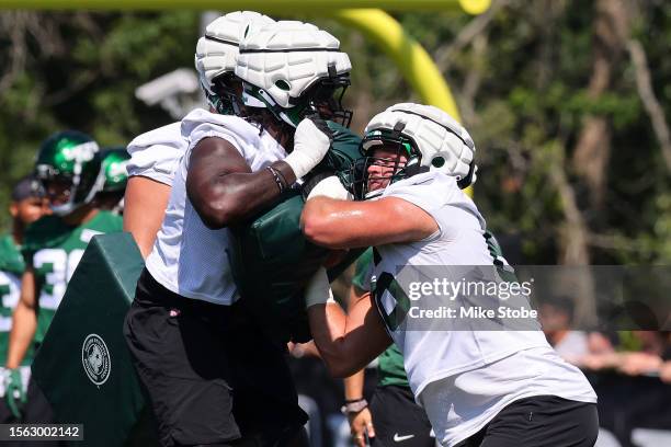 Carter Warren and Joe Tippmann of the New York Jets run drills during training camp at Atlantic Health Jets Training Center on July 22, 2023 in...