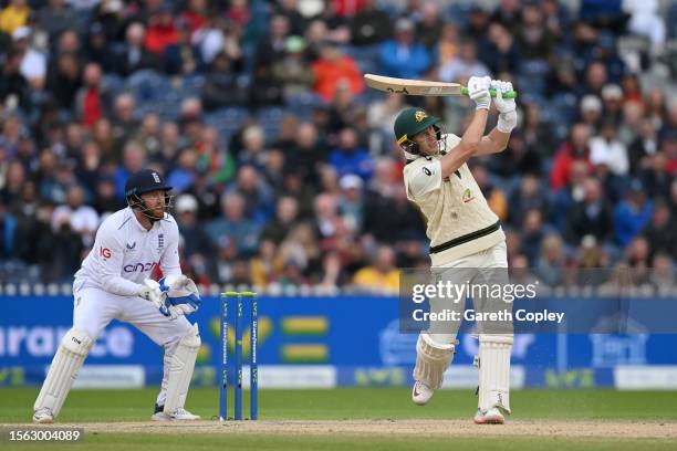 Marnus Labuschagne of Australia hits out for six runs watched by England wicketkeeper Jonathan Bairstow during day four of LV= Insurance Ashes 4th...