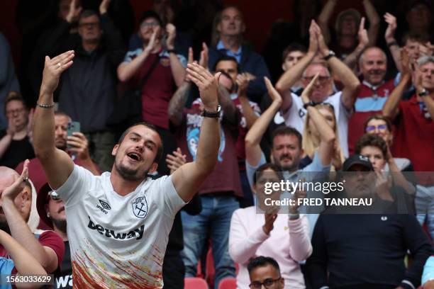 West Ham's supporters cheer during the pre-season friendly football match between Rennes and West Ham United FC at the Roazhon Park stadium in...