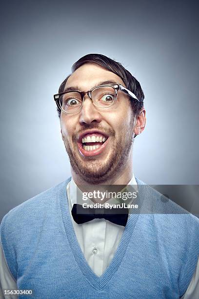 nerd student making a funny smiling face - bril met hoornen montuur stockfoto's en -beelden
