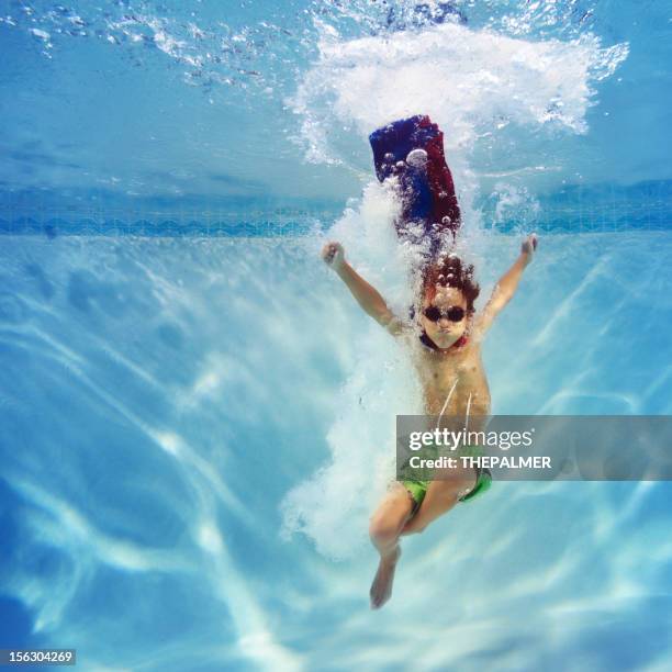 superhero boy diving into a swimming pool - taking the plunge 個照片及圖片檔