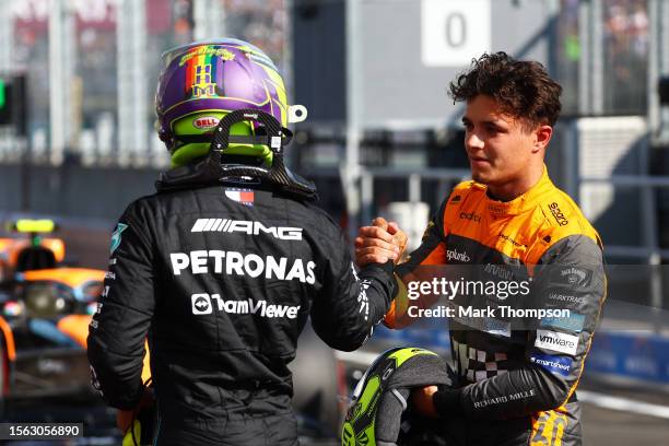 Pole position qualifier Lewis Hamilton of Great Britain and Mercedes and Third placed qualifier Lando Norris of Great Britain and McLaren talk in...