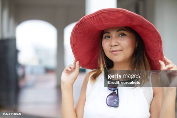 portrait of a young lady with huge red hat - big lips stock pictures, royalty-free photos & images